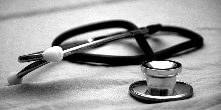 A stethoscope on a table- black an white image