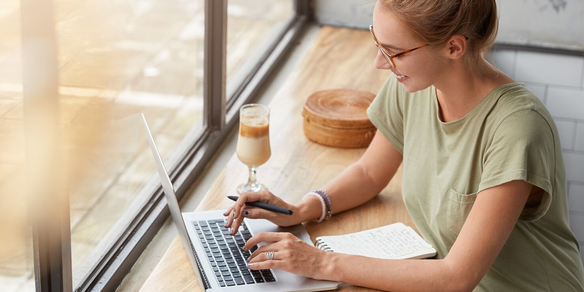 Woman on her laptop at a window