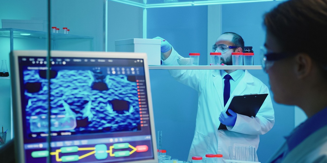 wo laboratory researchers analyzing medical imaging data on a clinical computer screen showcasing custom AI healthcare software solutions.