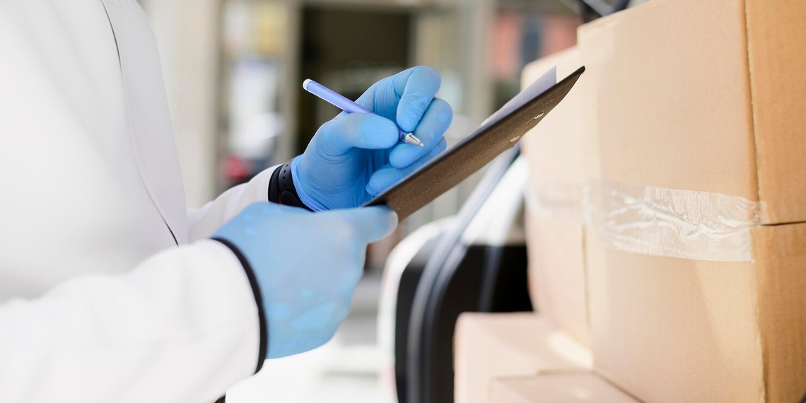 Medical supply chain, a woman signing off a new medical delivery.