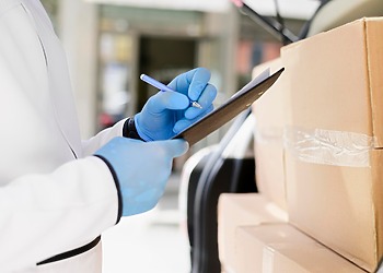 Medical supply chain, a woman signing off a new medical delivery.