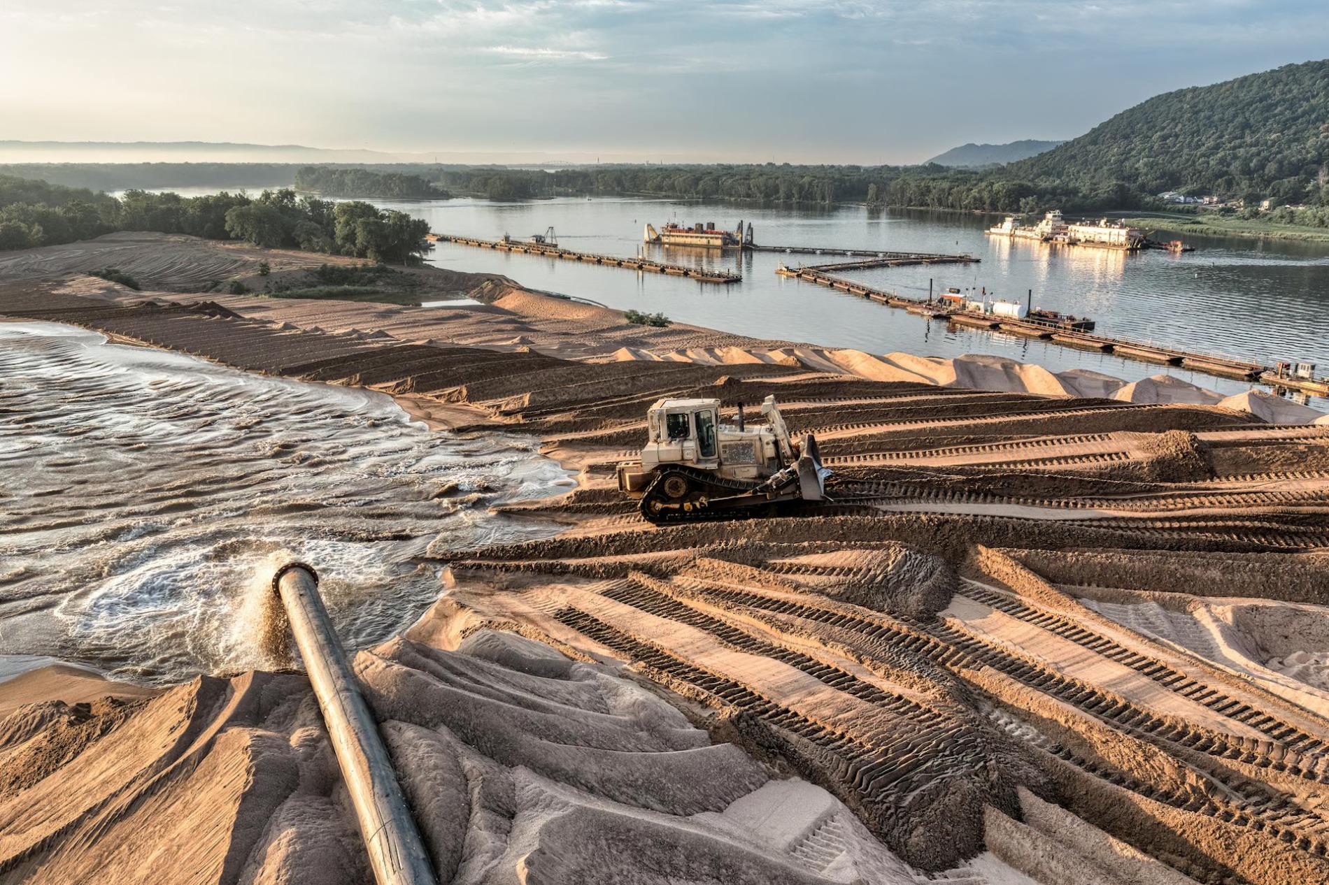 Aerial view of sand mining operation at sunrise next to a river in Reads Landing, Minnesota.
