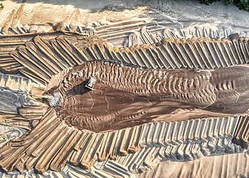 Aerial view of sand mining operations with machinery and patterned landscape in Reads Landing, MN.