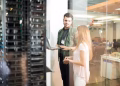 Engineer and assistant in front of a row of High-Performance Hosting servers.