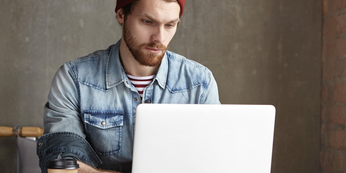 Journalist at his laptop using an AI-Generated Text checker
