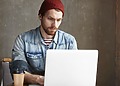Journalist at his laptop using an AI-Generated Text checker
