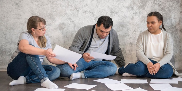 Parents sifting through document of their legal dispute with the school.