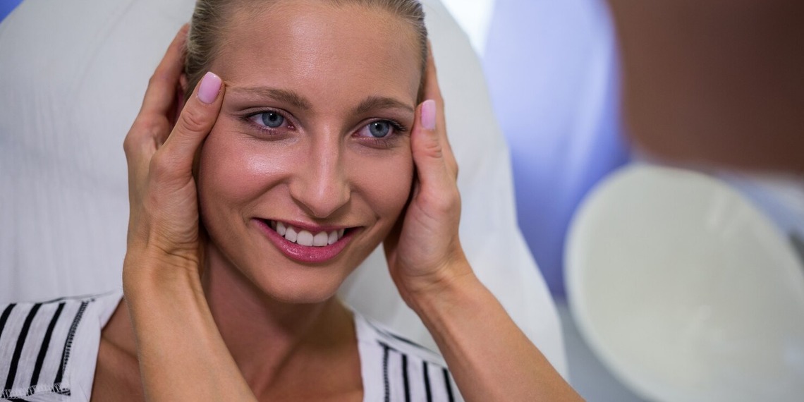 Blond 40 something woman getting facial treatment.