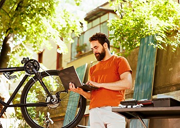 Man browsing the web on his laptop via local internet provider