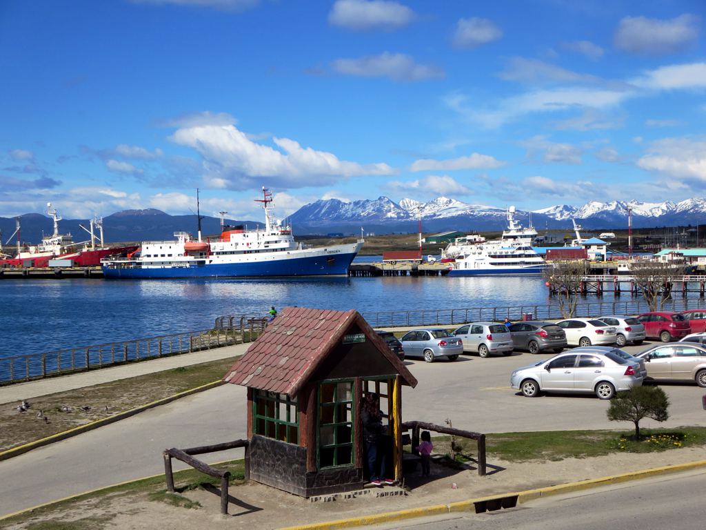 The small corrugated metal End of the World Post Office building on a wooden pier over the water at Lapataia Bay in Tierra del Fuego National Park.