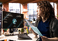 Woman engineer at her desk with pc screens turned on.