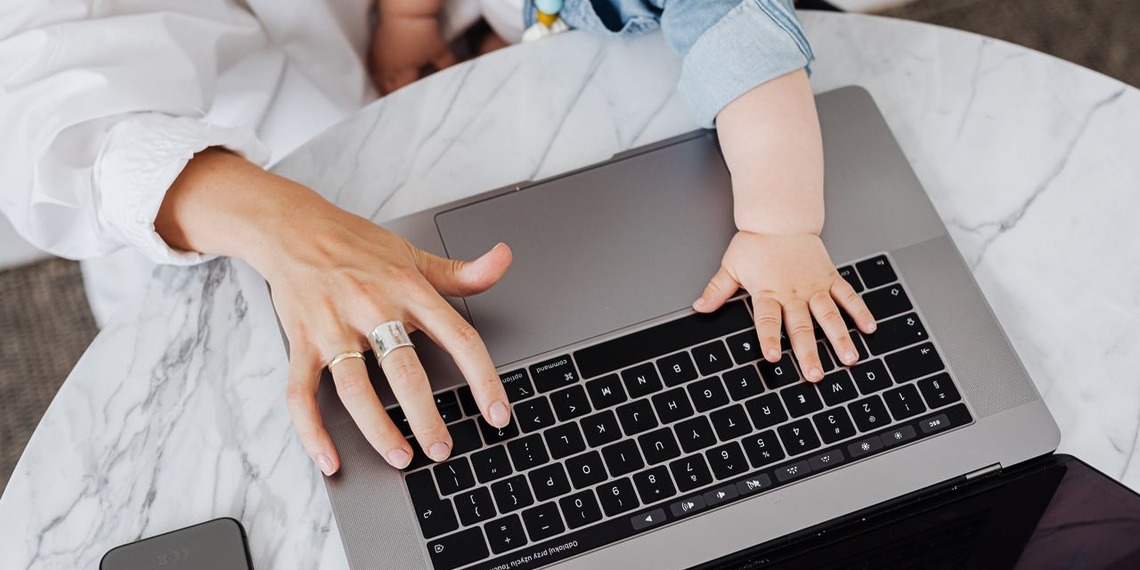 Mother and child's hands on a laptop