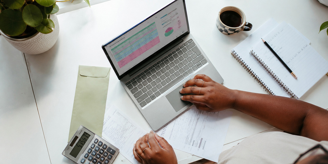 Virtual bookkeeping assistant managing digital financial records, invoices, and business accounts from a modern home office.