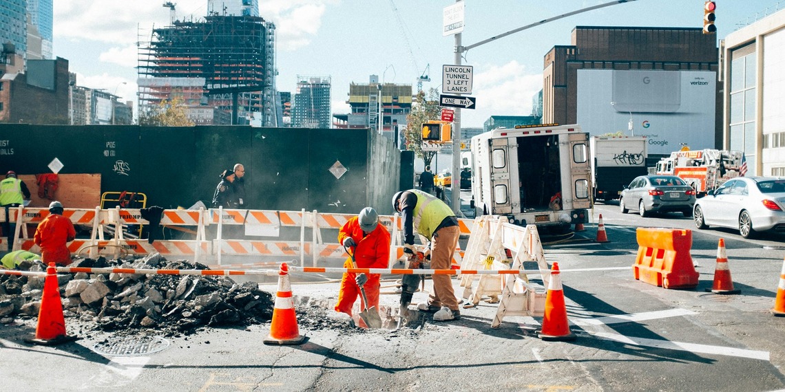 Construction worker wearing protective safety equipment at an active building site.