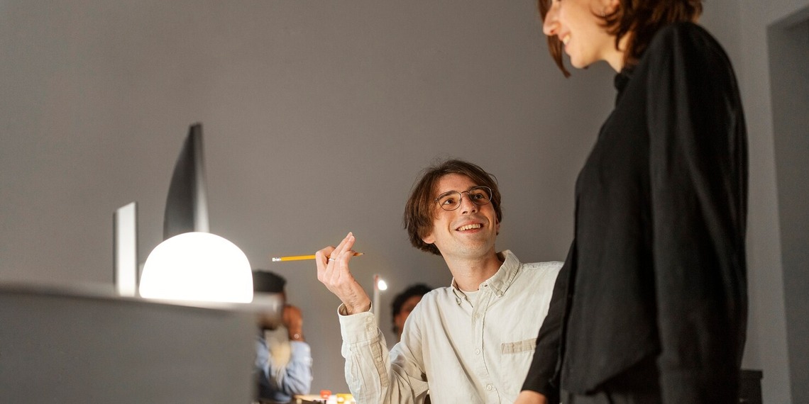 Two creative professionals collaborating in a modern workspace designed to encourage focus, innovation, and productivity.