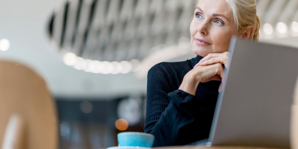 Experienced professional reviewing career opportunities and planning a midlife career transition while working on a laptop.