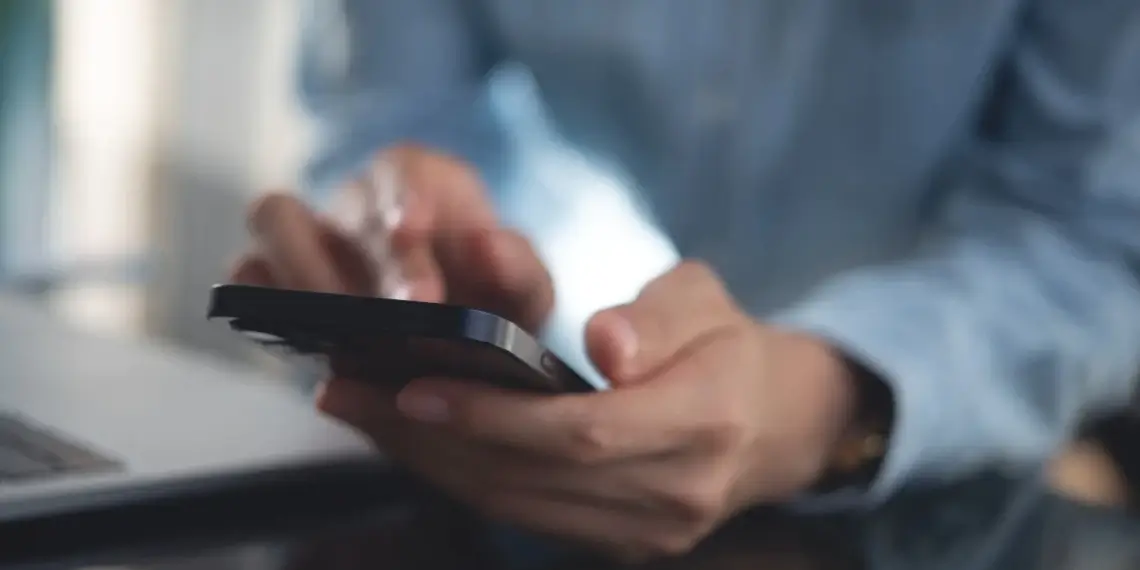 Person checking an unknown phone number on a smartphone to identify a caller and verify contact information.