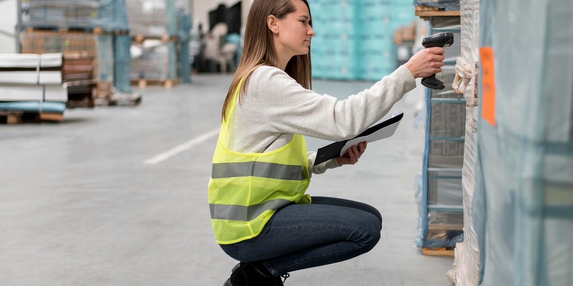 Warehouse employee scanning a package barcode to improve inventory accuracy and reduce stock management errors.