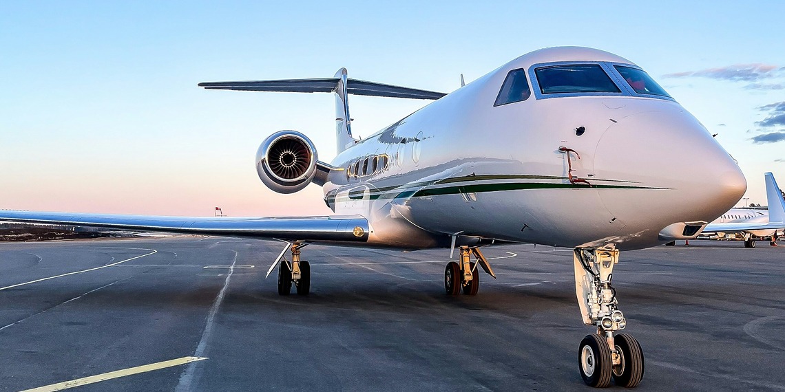A private jet sits on the airport tarmac