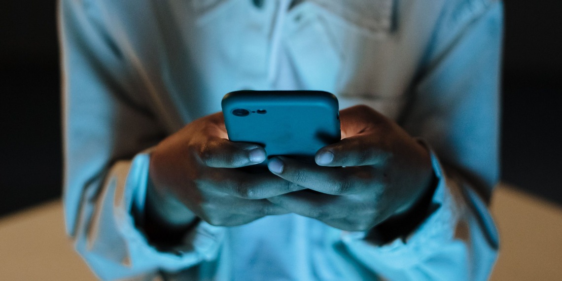 Person using a smartphone indoors at night