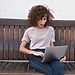 Person using a MacBook to browse Safari and manage browser settings