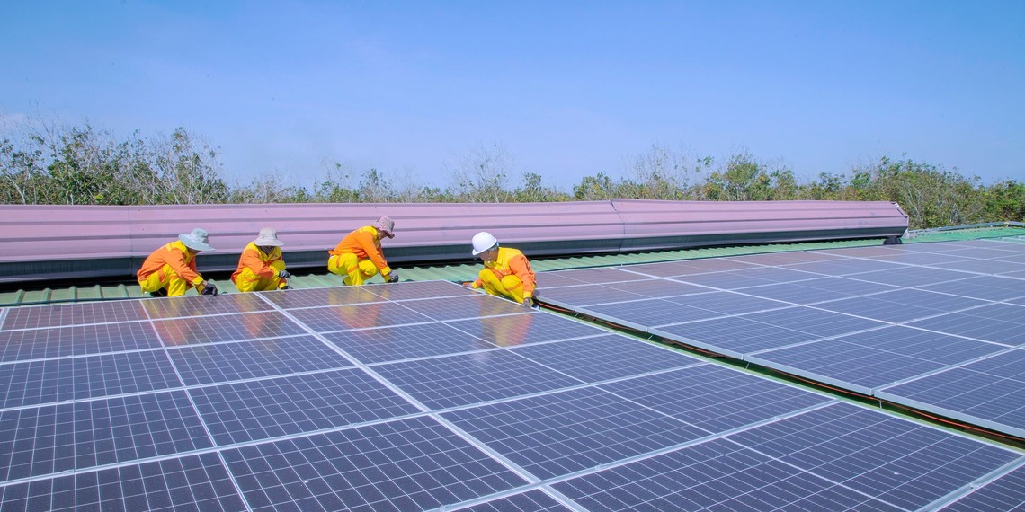 Solar panel installation on a rooftop on a sunny day.