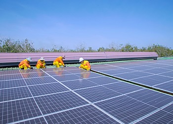 Solar panel installation on a rooftop on a sunny day.