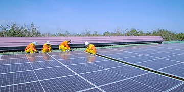 Solar panel installation on a rooftop on a sunny day.