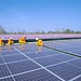 Solar panel installation on a rooftop on a sunny day.