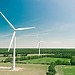 A shot of two wind turbines in a field in rural France