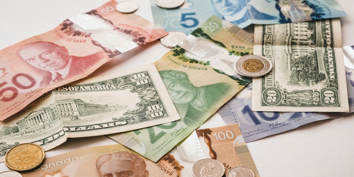 U.S. and Canadian currencies on a white table.