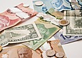 U.S. and Canadian currencies on a white table.