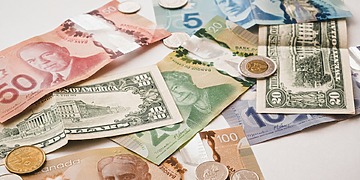 U.S. and Canadian currencies on a white table.