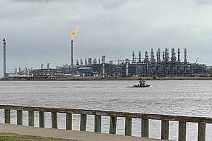 A view of an oil refinery across a river.