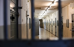 Hallway of a European jail behind bars.