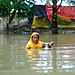 A woman wades through floodwaters in coastal Bangladesh