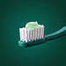 Pale green toothpaste on a green toothbrush.