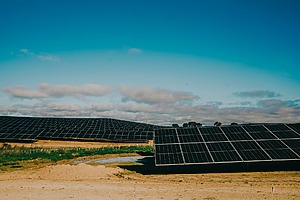 Solar panels installed across a desert environment.