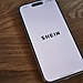 An Iphone sitting on the table with the SHEIN app open