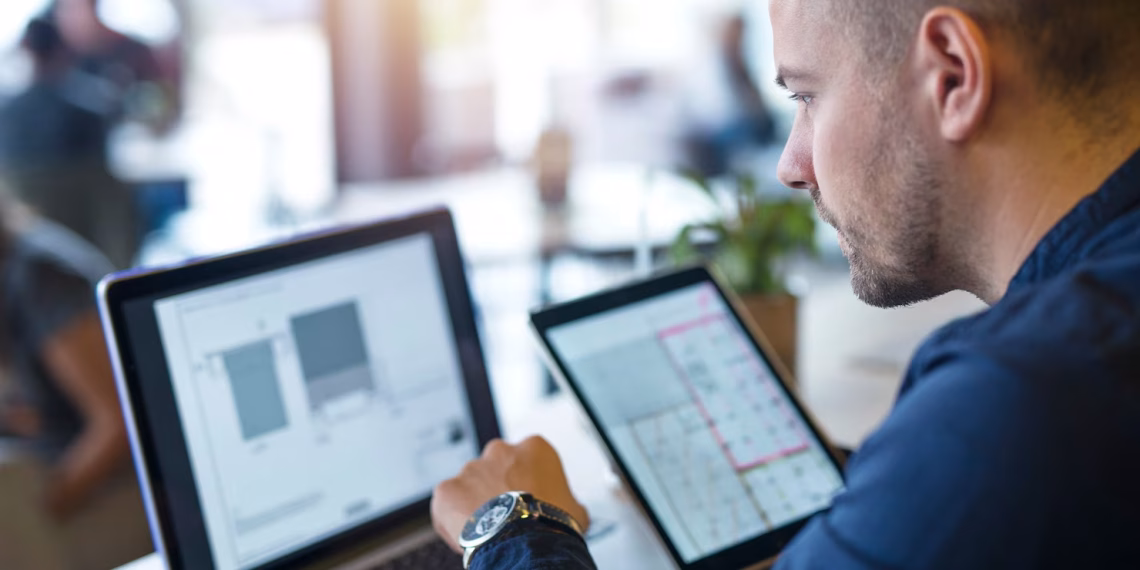 Business professional working with a laptop and tablet