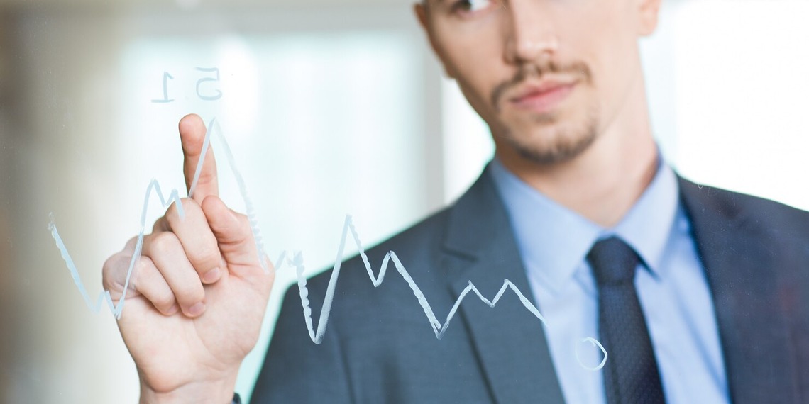 Business professional drawing an upward financial growth chart
