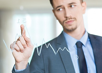 Business professional drawing an upward financial growth chart