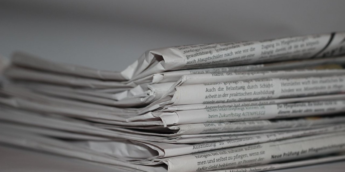 Stack of folded print newspapers