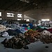 A shot from inside an abandoned clothing factory in Cambodia, where workers sort through clothes