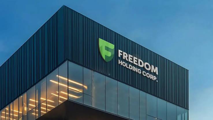 Freedom Holding Corp. logo displayed on a modern office building