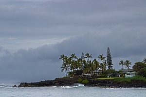 A small house on an island surrounded by open ocean water
