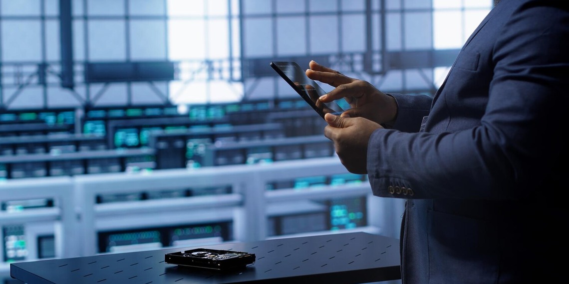 Professional using a tablet beside modular fintech infrastructure
