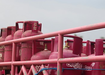 A group of pink gas tanks sitting next to each other