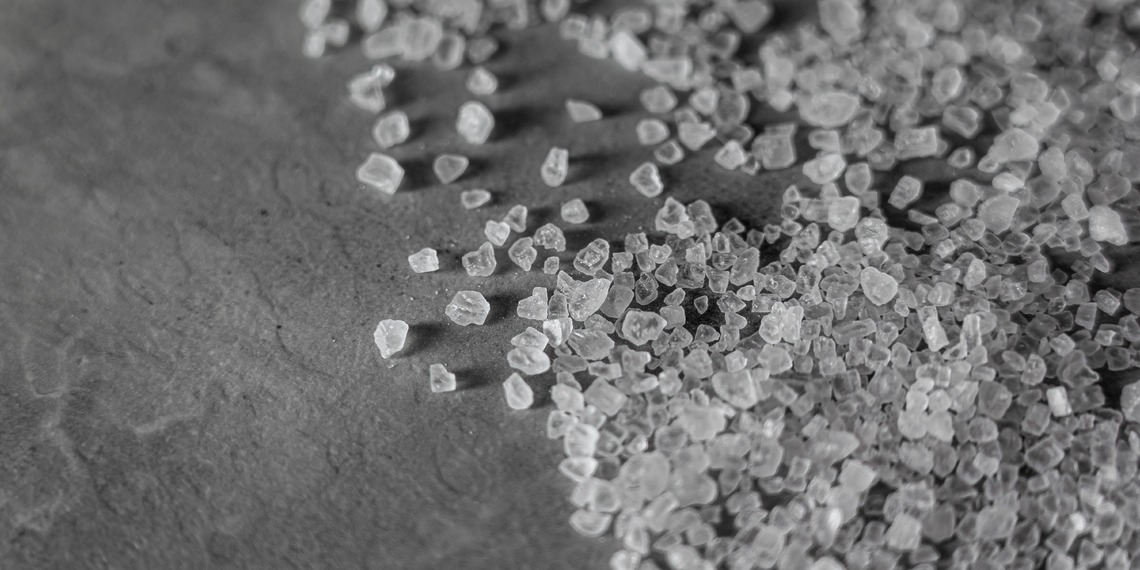 Close-up of rock salt granules. Photo Credit: Castorly Stock
