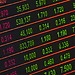 A digital stock market data display showing colorful financial numbers and trends.